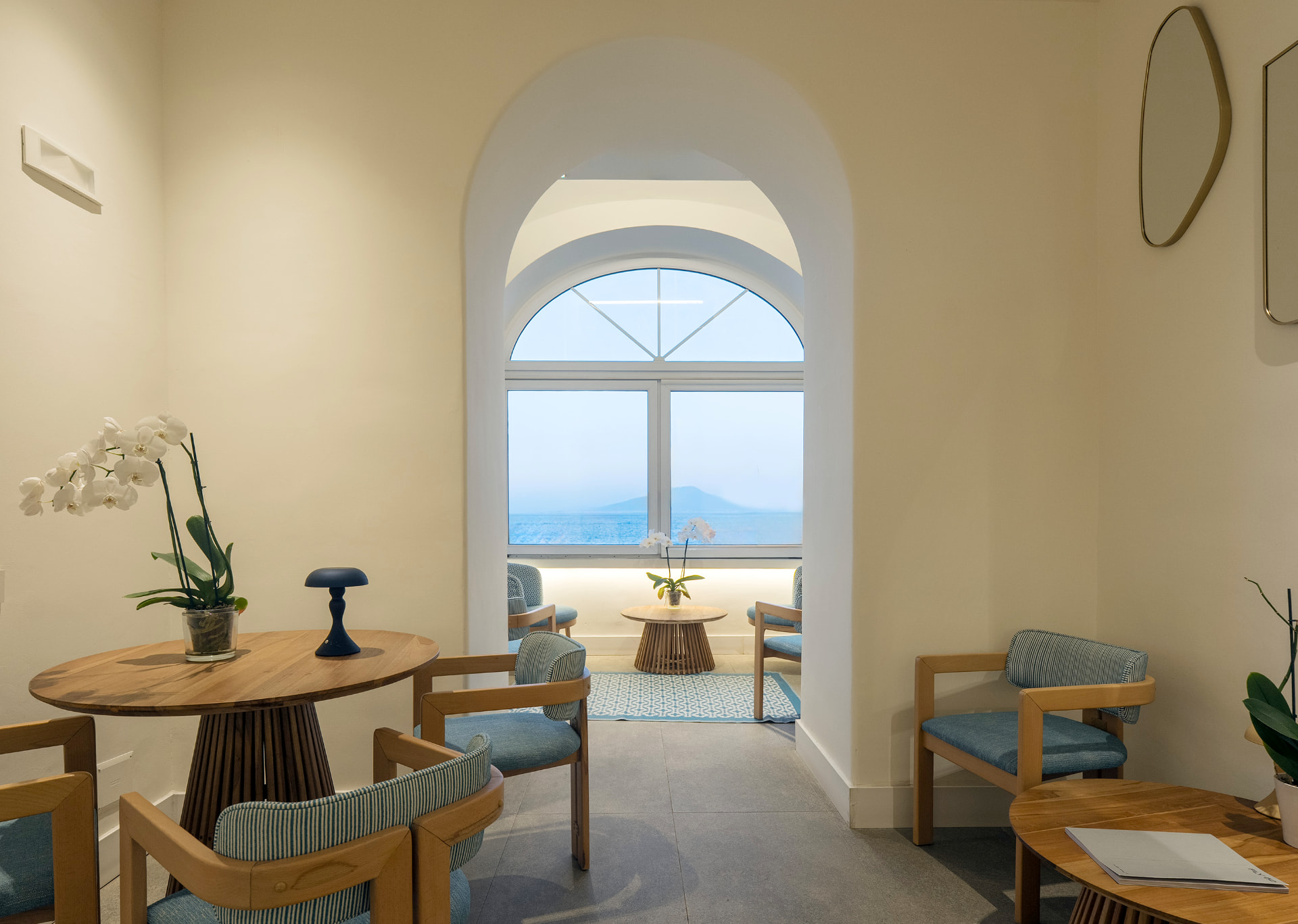 Salotto di Relais Maresca con finestra ad arco sul golfo di Napoli